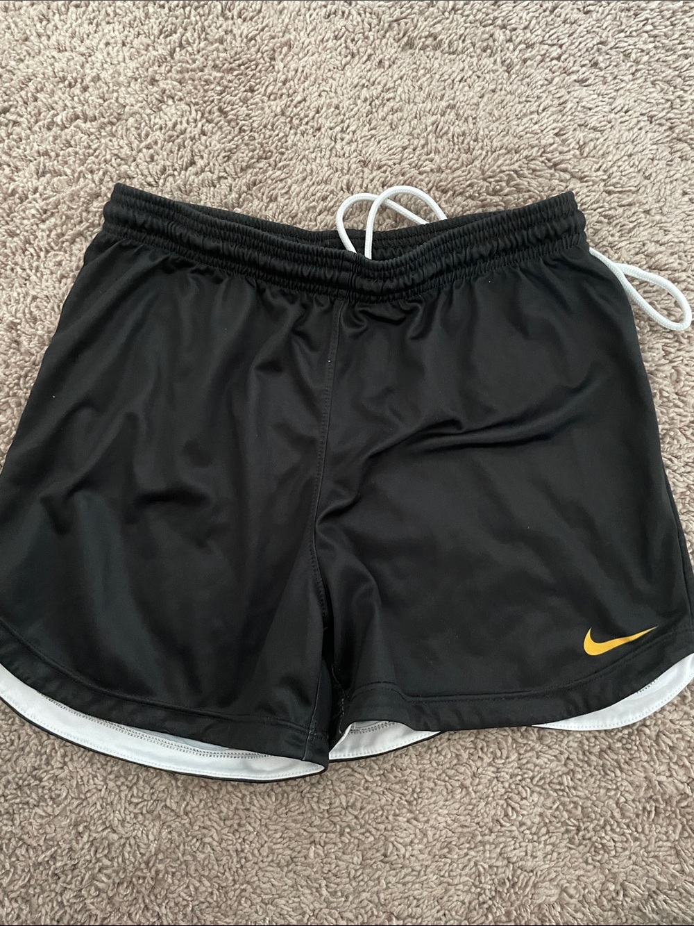 Nike Women’s Black Athletic Shorts with Yellow Swoosh Accent